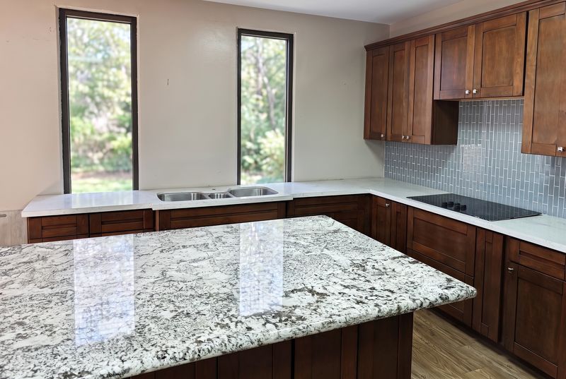 A Cherrywood Shaker kitchen with a speckled stone-look island