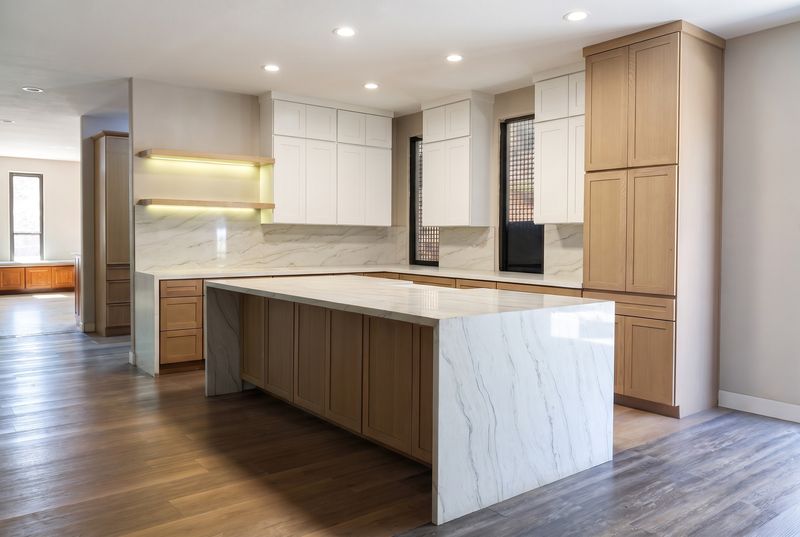 A white and oak Shaker kitchen with a waterfall island in our showroom