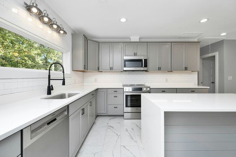 A gray Shaker kitchen with a white island