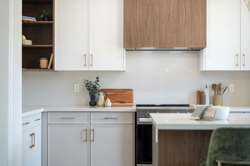 White upper and gray lower cabinets with a wood hood